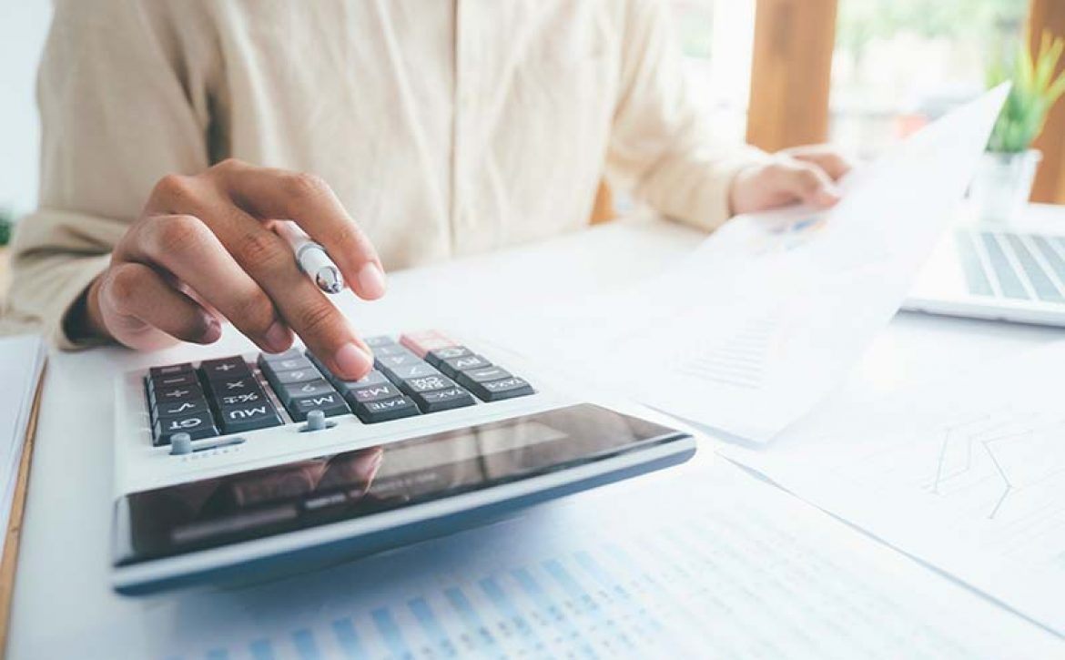 Male accountant or banker use calculator.
