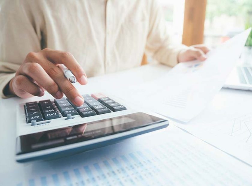 Male accountant or banker use calculator.